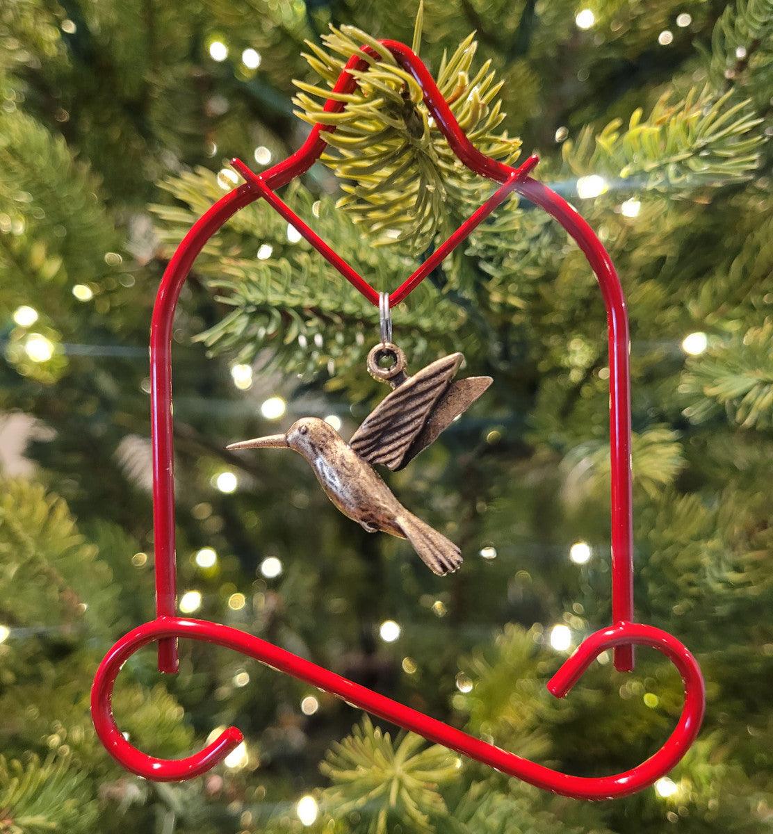 Pop's red charm ornament with a brass hummingbird charm on a Christmas tree