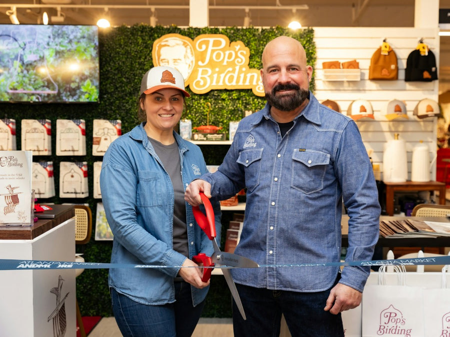 Bethany Sloan and Pete Stankovich cutting the ribbon at the Pop's Birding showroom at AmericasMart Atlanta