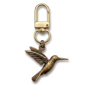 Brass hummingbird charm on a gold swivel clasp