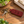 Burgundy leather hummingbird keychain with keys on a wooden desk