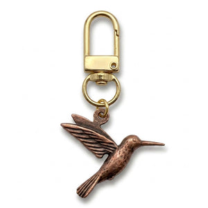 Copper hummingbird charm on a gold swivel clasp