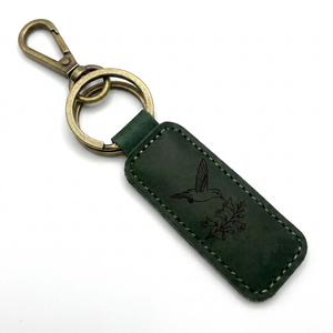 Forest green leather hummingbird keychain with a brass lobster clasp and two key rings