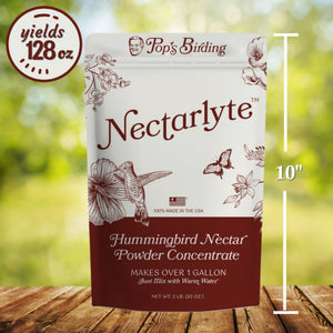 Nectarlyte hummingbird nectar powder concentrate package on a wooden surface with a blurred green background