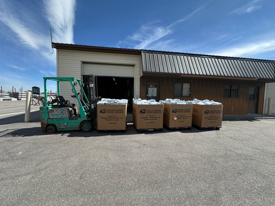 Pop's Birding warehouse in Idaho Falls, Idaho, with a forklift and pallets of packed orders out front